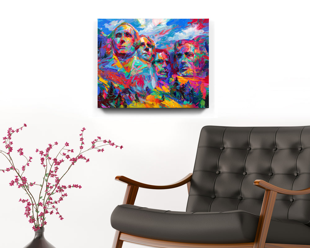 Mount Rushmore | Hope For a Brighter Future painted by Blend Cota Art Print on Cardstock from Blend Cota Studios with painting hanging on a white wall behind a black leather armchair