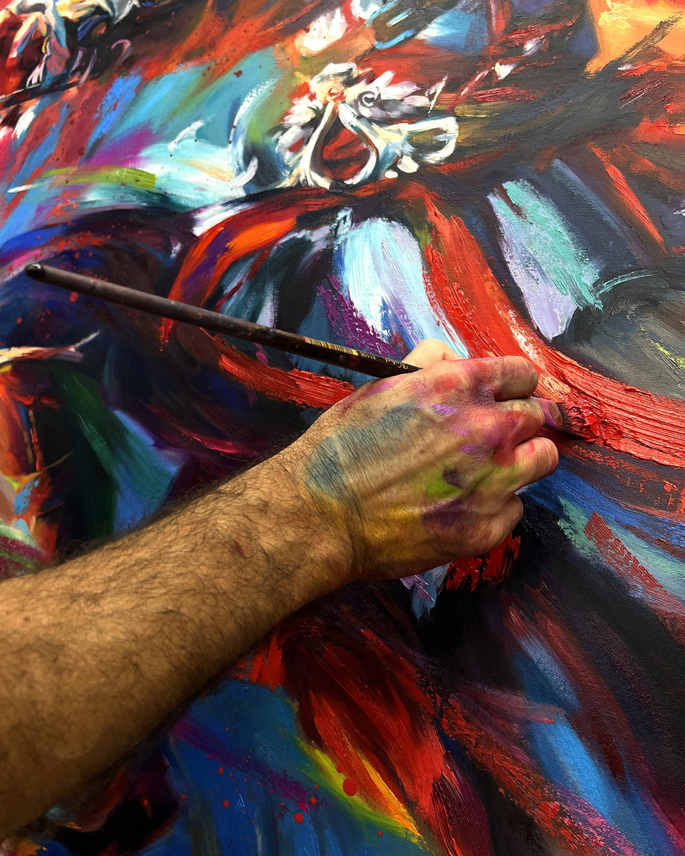 Detailed view of artist hand embellishing limited edition painting.